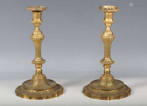 A pair of 18th century style cast ormolu candlesticks with o...