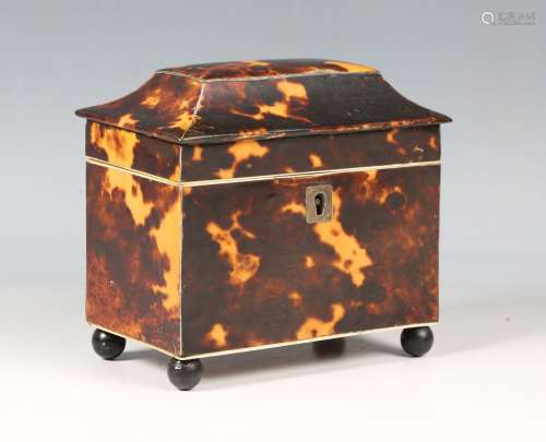 An early 19th century tortoiseshell tea caddy of sarcophagus...