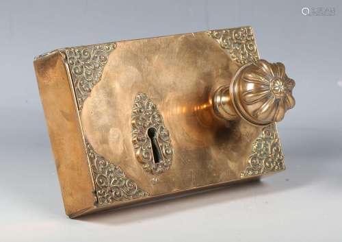 A 17th century style brass door lock plate with foliate cast...