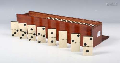 A late Victorian set of ebony and bone dominoes, contained i...