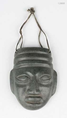 A pre-Columbian Mayan style carved green hardstone mask, pos...