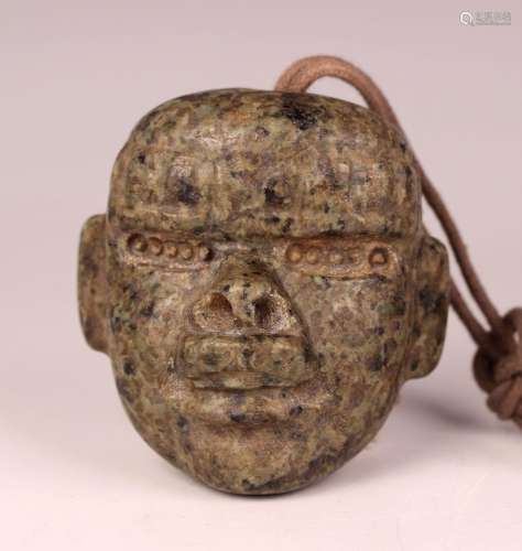 A pre-Columbian Olmec style carved mottled green hardstone t...