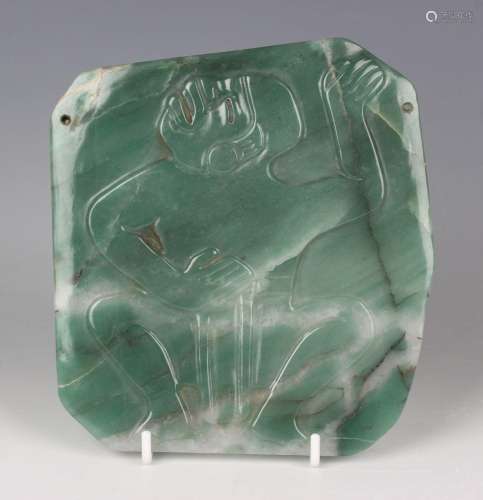 A pre-Columbian Olmec style carved apple green jade pectoral...