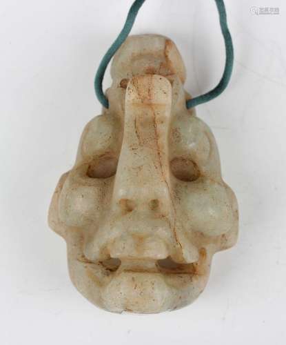 A pre-Columbian Mayan style carved pale green hardstone mask...