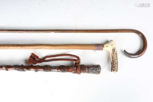 A late Victorian holly walking cane with silver mounted hand...