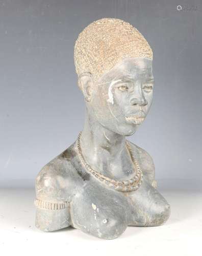 A late 20th century African carved stone head and shoulders ...