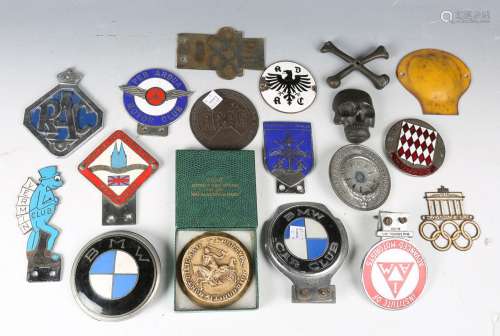 A collection of various motoring badges, including an enamel...