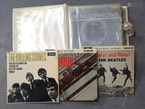 A small collection of 7-inch records, including EPs by The B...