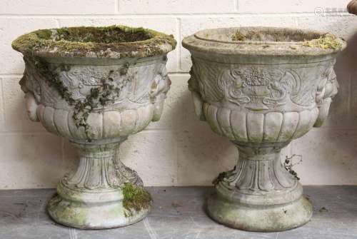 A pair of 20th century cast composition stone garden urns of...