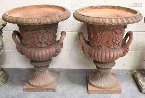 A pair of 20th century terracotta garden urns, each of typic...