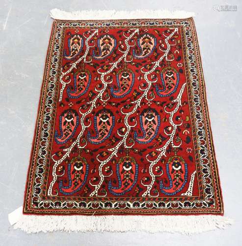 A small Persian rug, late 20th century, the red field with o...