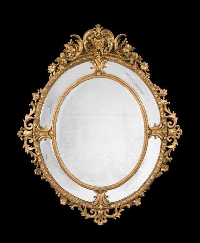 A CARVED GILTWOOD AND GESSO OVAL WALL MIRROR, MID 19TH CENTU...