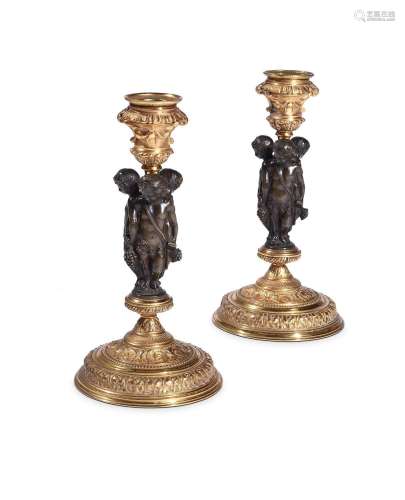 A PAIR OF FRENCH GILT AND PATINATED FIGURAL CANDLESTICKS, LA...