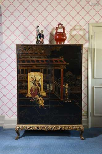 A BLACK LACQUER AND GILT CHINOISERIE DECORATED CUPBOARD OR W...