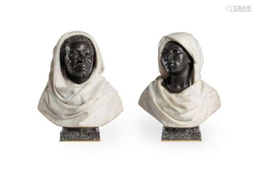 A PAIR OF ITALIAN BRONZE AND WHITE MARBLE BUSTS OF AN AFRICA...