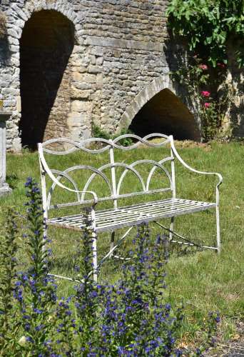 A WROUGHT IRON STRAPWORK BENCH, 20TH CENTURY, IN THE REGENCY...