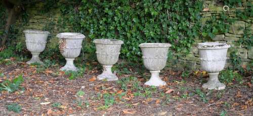 A SET OF FIVE STONE COMPOSTION URNS, IN 19TH CENTURY STYLE, ...