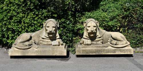 A PAIR OF LARGE COMPOSITION STONE LIONS, IN THE MANNER OF TH...