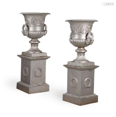 A PAIR OF HANDYSIDE PATTERN CAST IRON URNS AND PEDESTALS, LA...
