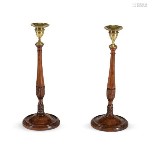 A PAIR OF MAHOGANY AND BRASS MOUNTED CANDLESTICKS, IN THE 18...