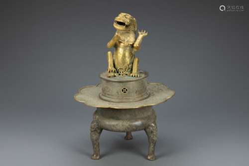 Five Dynasties gilt bronze censer in form of a lion supporte...