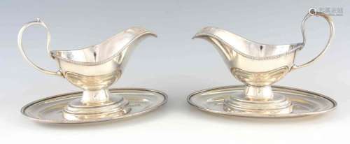 A LARGE PAIR OF 19TH CENTURY SILVER PLATED SAUCE BOATS ON FI...