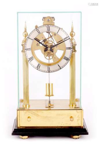 A 20TH CENTURY BRASS ELECTRIC MANTEL CLOCK UNDER GLASS CABIN...