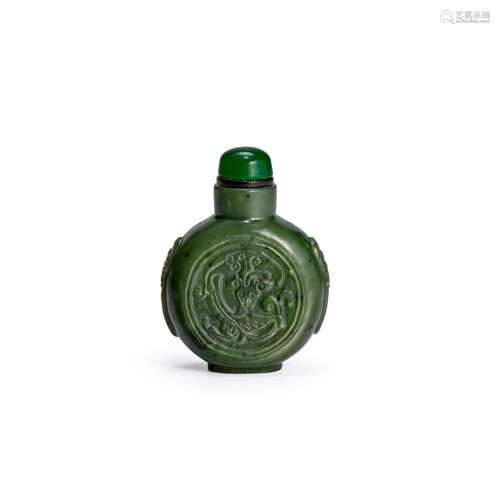 A SPINACH-GREEN CARVED JADE SNUFF BOTTLE Possibly imperial, ...