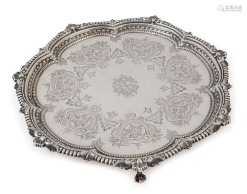 An antique English sterling silver salver with engraved deco...