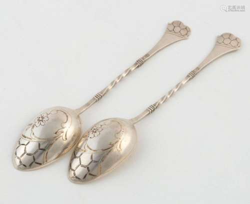 A pair of Russian silver teaspoons with engraved decoration,...