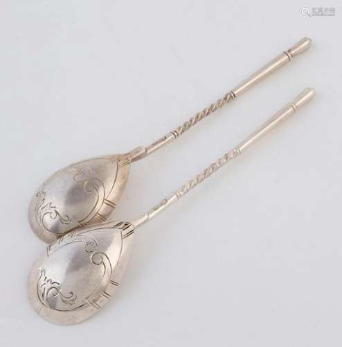 A pair of Russian silver teaspoons with engraved decoration ...