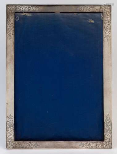 A sterling silver picture frame with blue velvet backing, ea...