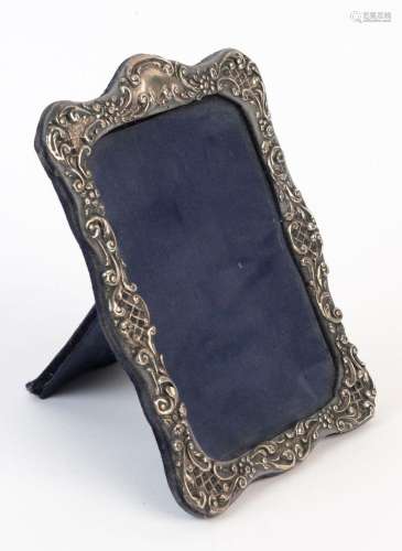 A sterling silver picture frame with blue silk and velvet ba...
