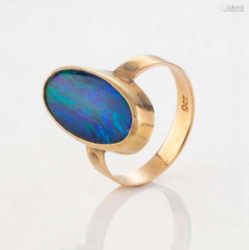 An antique 9ct rose gold ring set with oval blue/green opal,...