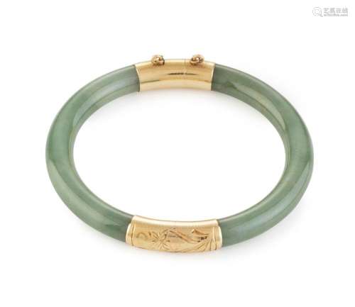 A Chinese jade bangle with 14ct yellow gold mounts, 20th cen...