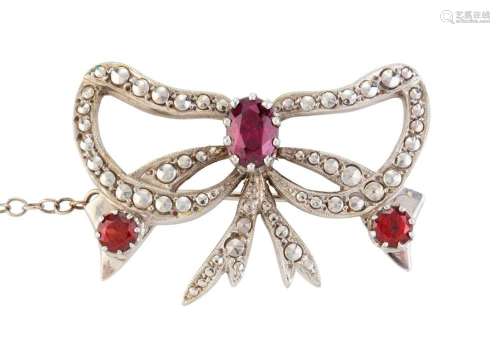 A vintage 9ct white gold bow brooch set with three cut garne...