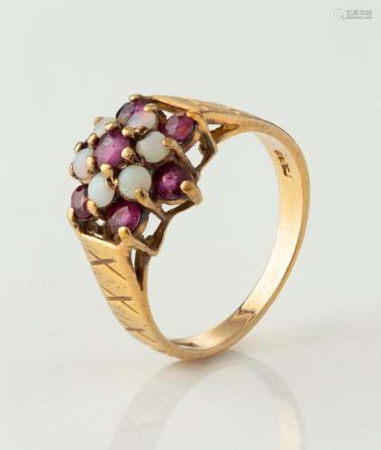 A vintage yellow gold ring set with opals and rubies, early ...