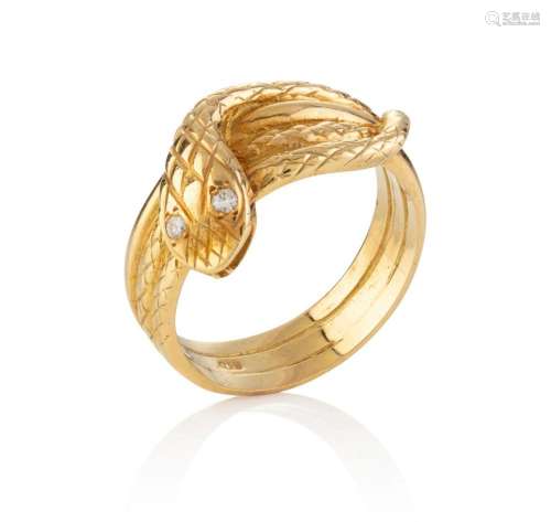 An 18ct yellow gold snake ring with diamond set eyes, stampe...