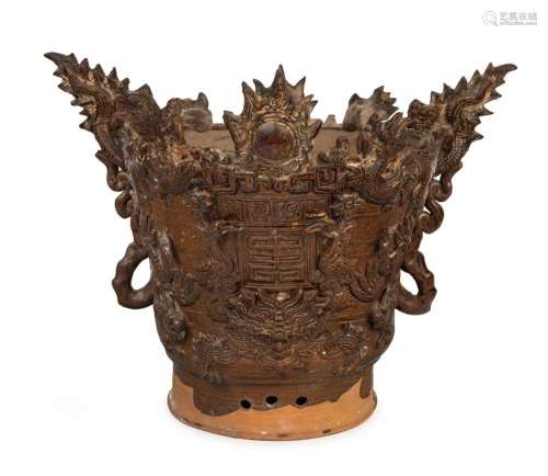 An antique Chinese pottery temple vase with dragon decoratio...