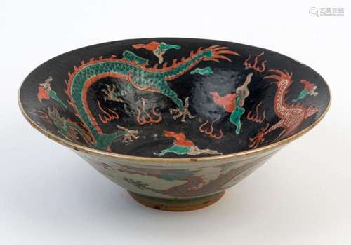 A Chinese ceramic dragon bowl with black ground, Republic pe...