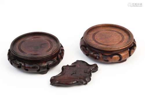 Three Chinese carved wooden stands, 20th century, the larges...