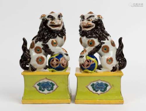 A pair of Chinese ceramic Foo dog statues, 19th/20th century...