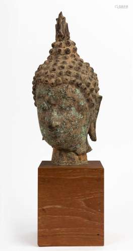 A bronze Buddha head on timber stand26cm high, 45cm high ove...