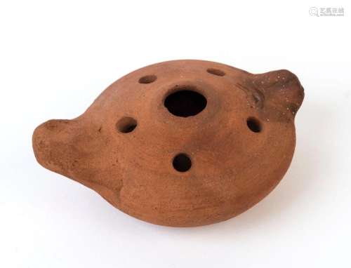A pottery oil lamp, the upper surface adorned with a Menorah...