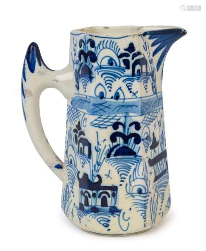 An antique tin glazed earthenware blue and white jug of tape...