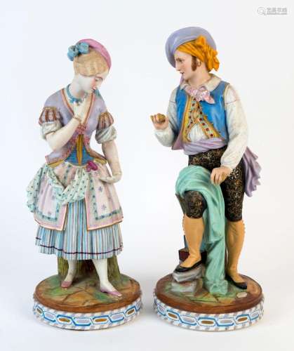A pair of Continental bisque porcelain statues with hand-pai...