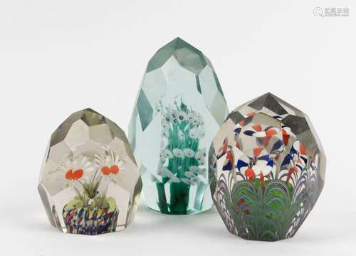 Three Murano glass paperweights with coloured floral inclusi...