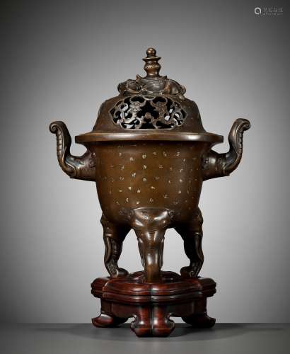 A LARGE GOLD-SPLASHED BRONZE 'ELEPHANT' TRIPOD CENSER AND CO...