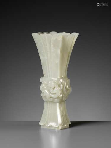 A PALE CELADON JADE PETAL-LOBED ARCHAISTIC 'CHILONG' VASE, Q...