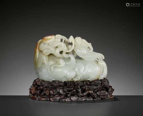 A CELADON AND RUSSET JADE 'QILIN AND CRANES' GROUP, 18TH CEN...